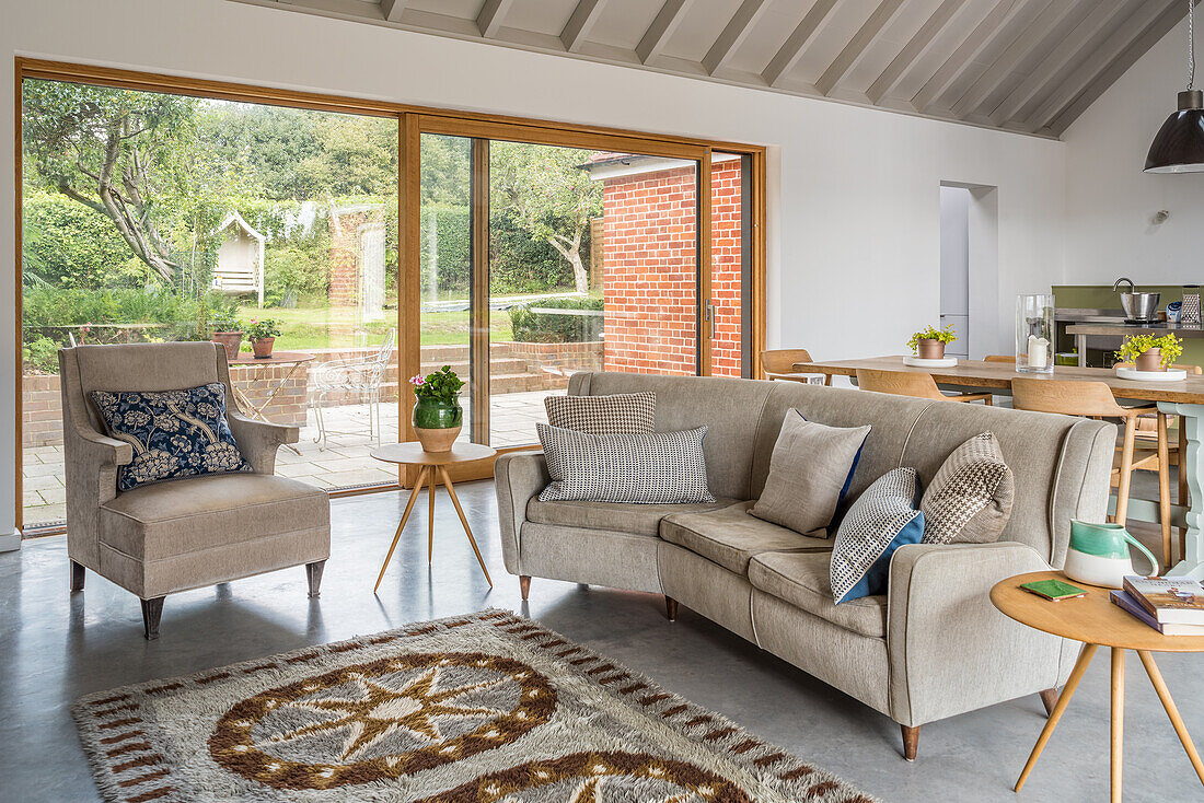 Pale sofa set in front of patio doors