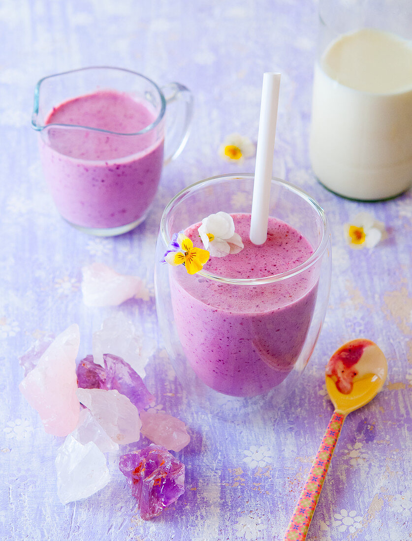 Blueberry smoothies with edible flowers