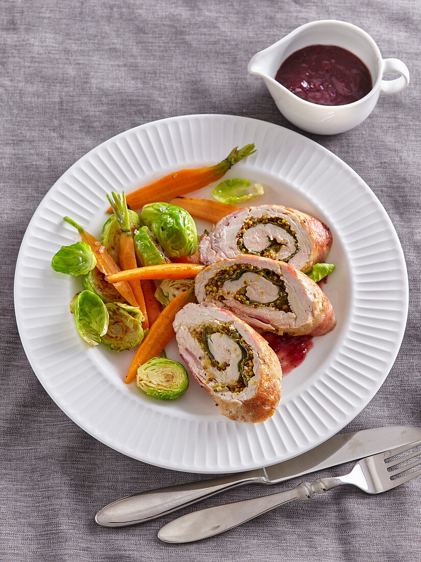 Turkey roll with vegetables and cranberry sauce