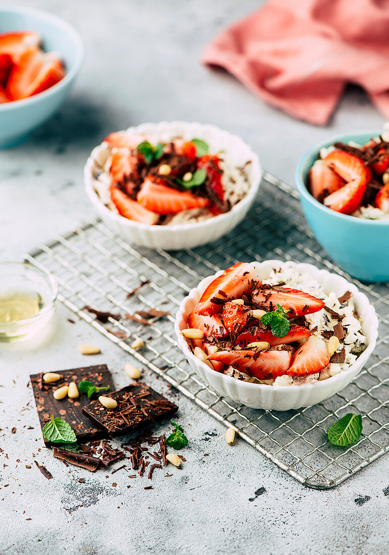 Stracciatella creme with marinated strawberries and pine nuts