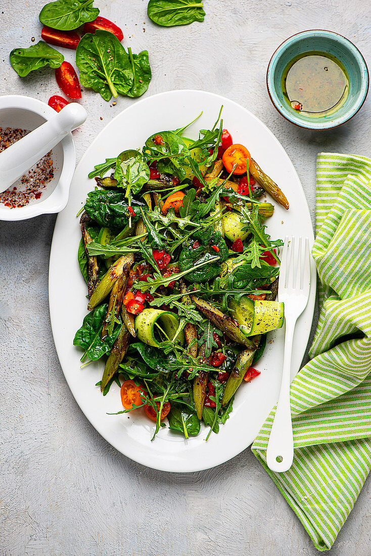 Asparagus salad with spinach, cucumber and tomato