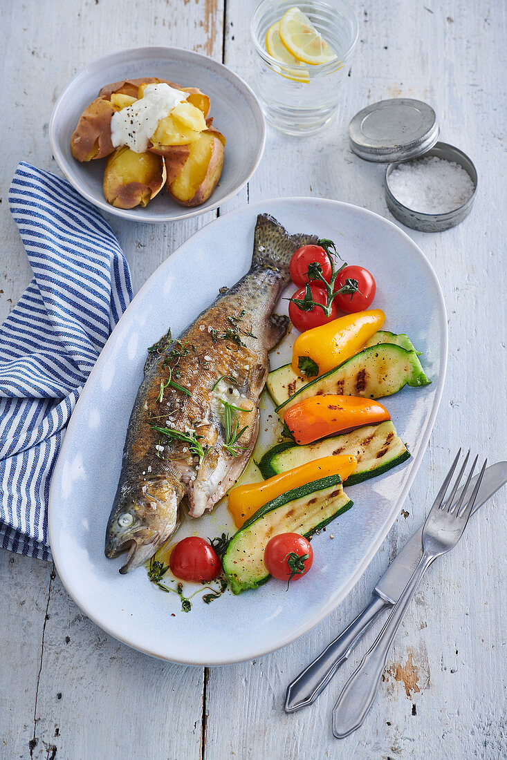 Trout on grill with grilled vegetables