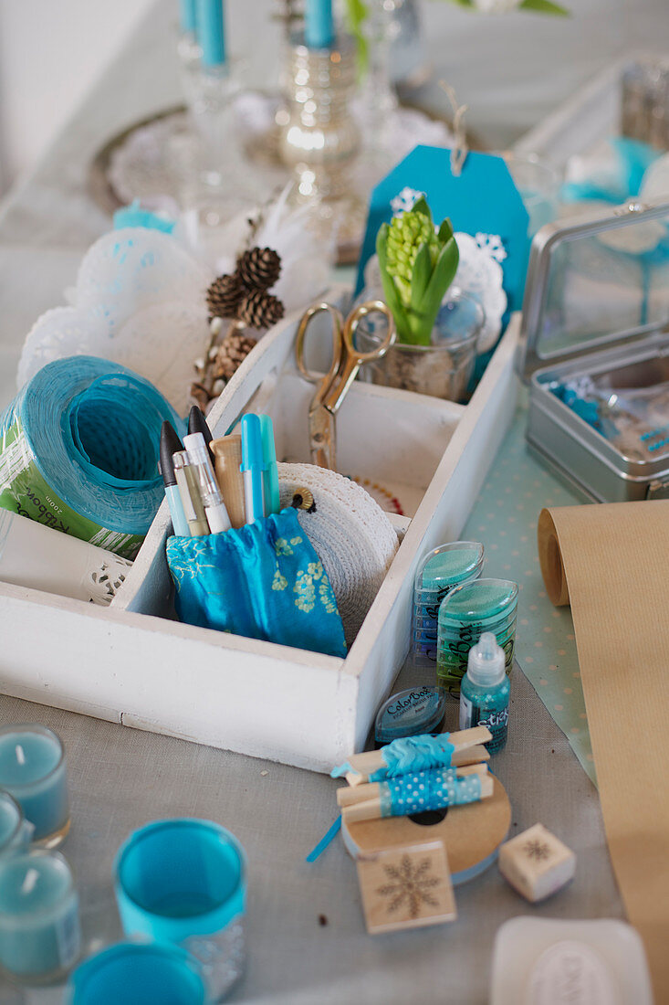 Wooden box with decorative and craft materials in blue and white