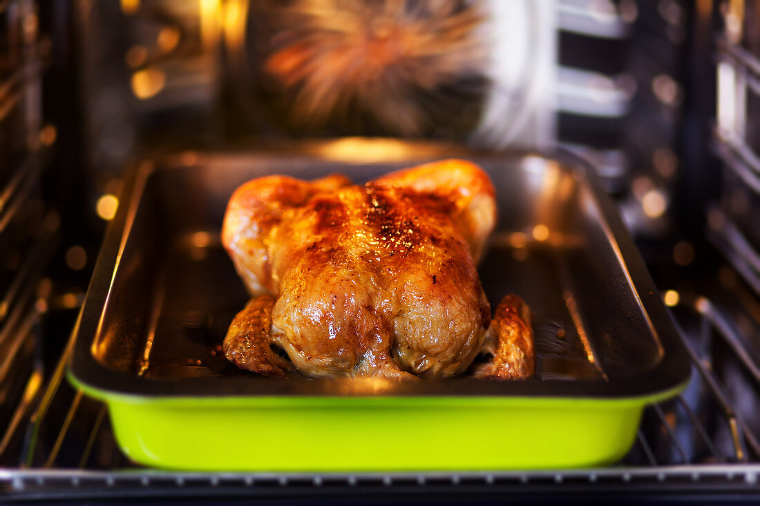 Fried chicken with butter in an oven