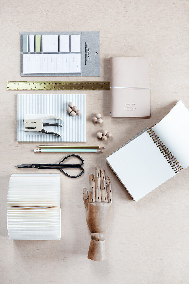 Writing utensils - notebooks, notepads, pencils, stapler, and wooden mannequin hand for art