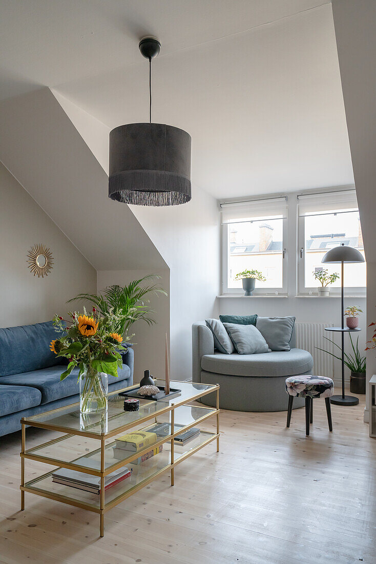 Glass coffee table, sofa, and round corner chair in the living room