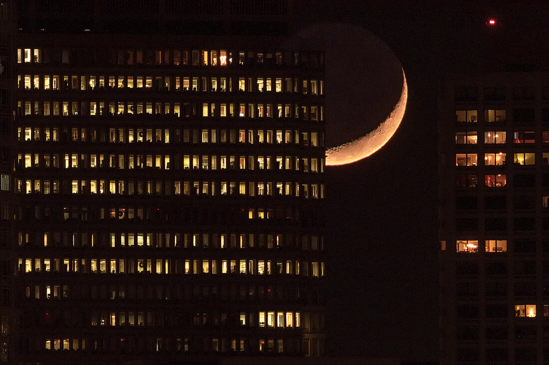 Crescent Moon behind skyscrapers
