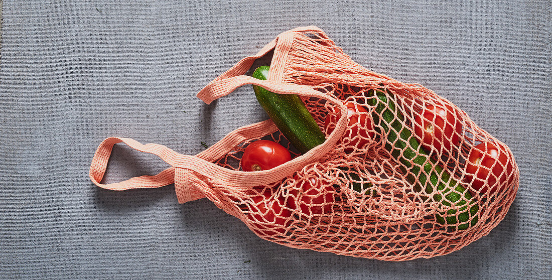 Tomatoes and cucumber in a shopping net