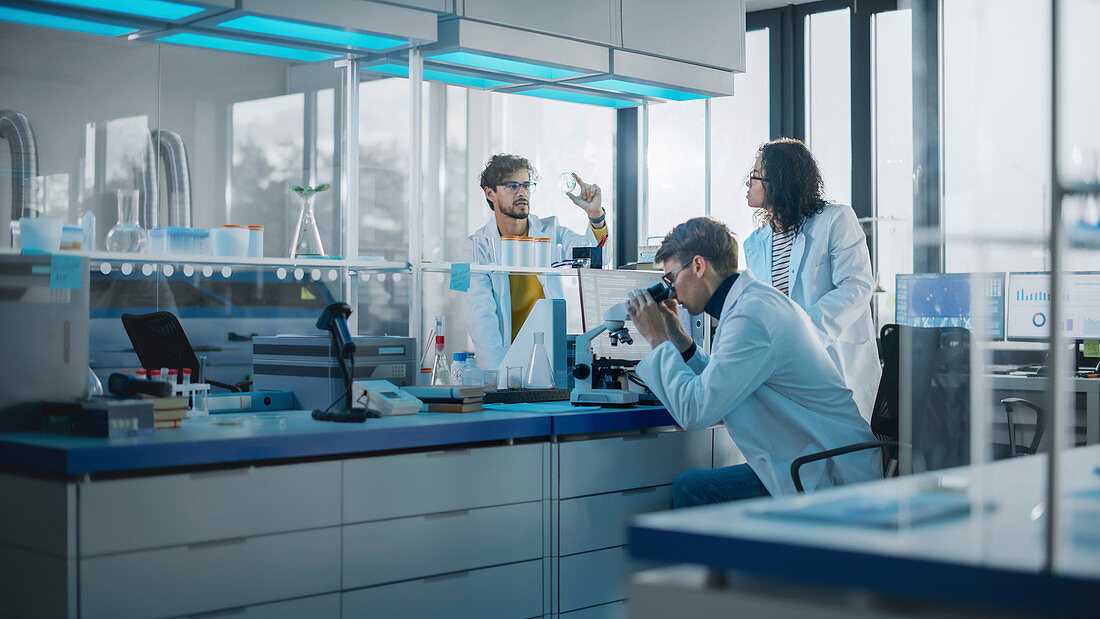 Team of young scientists working in laboratory