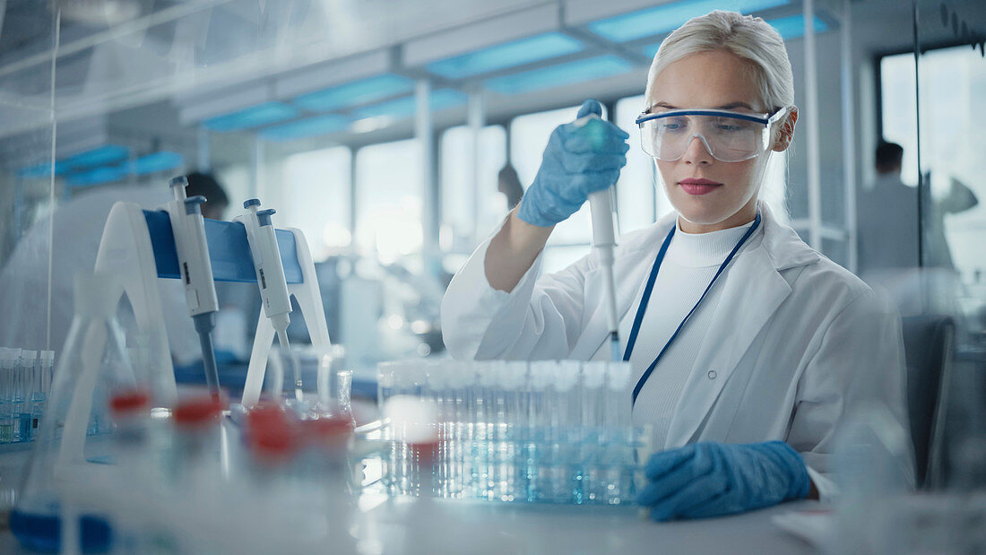 Scientist using a micropipette