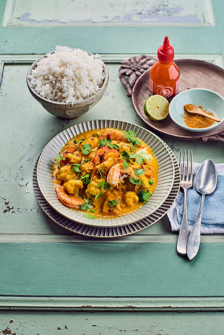 Pumpkin curry with shrimp, peas, broccoli, cauliflower and rice
