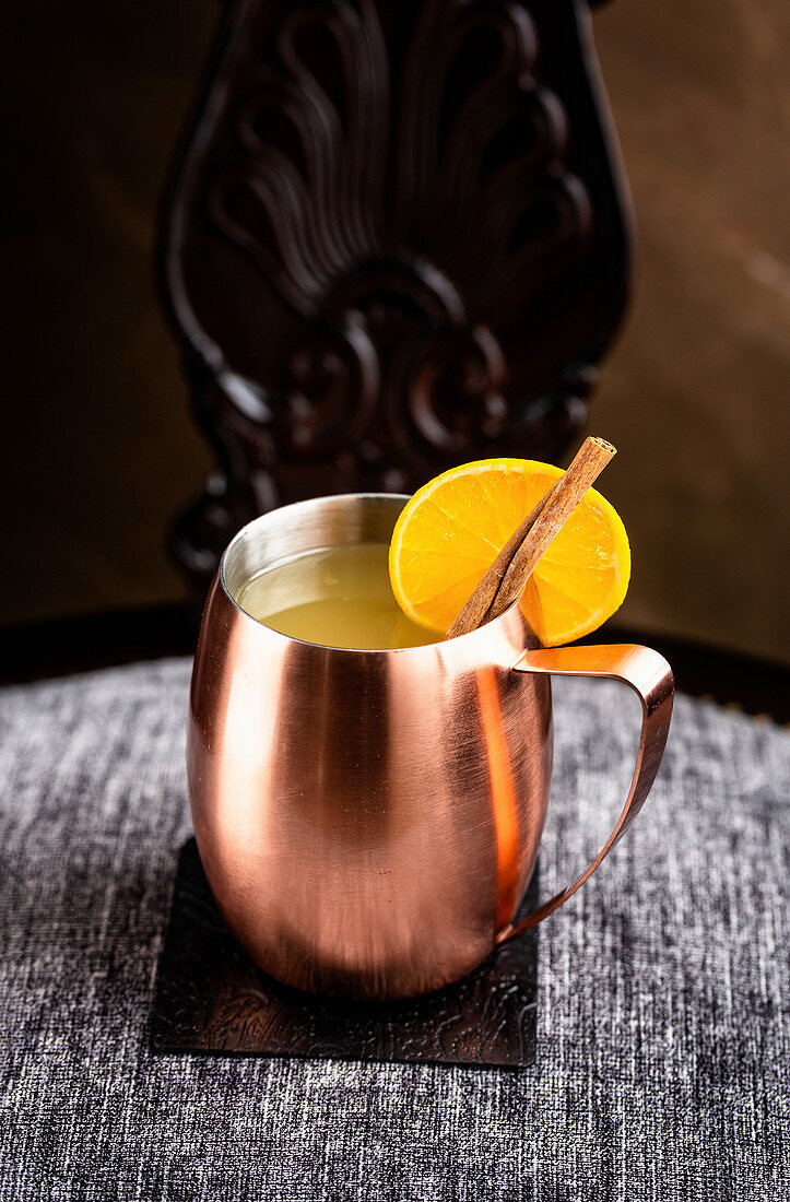 Mule with orange served in a traditional copper mug