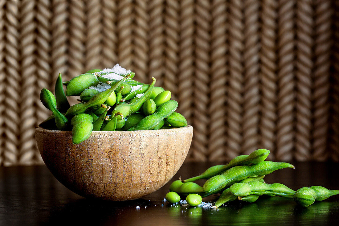 Fresh soybeans with sea salt in a wooden bowl