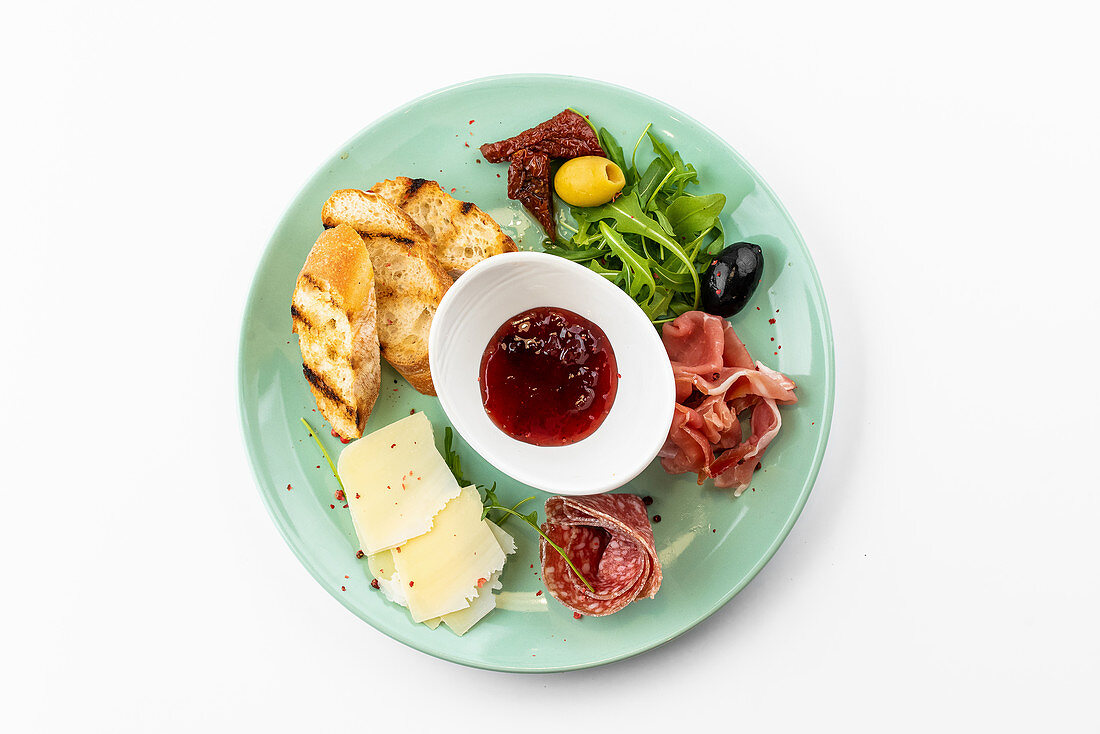 Antipasti plate - ham, salami, croutons, jam and cheese