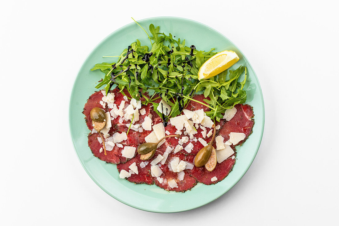 Beef carpaccio with arugula and cheese