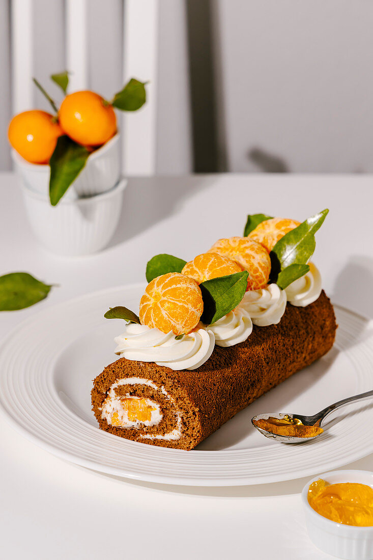 Chocolate roulade with vanilla cream cheese frosting and tangerines