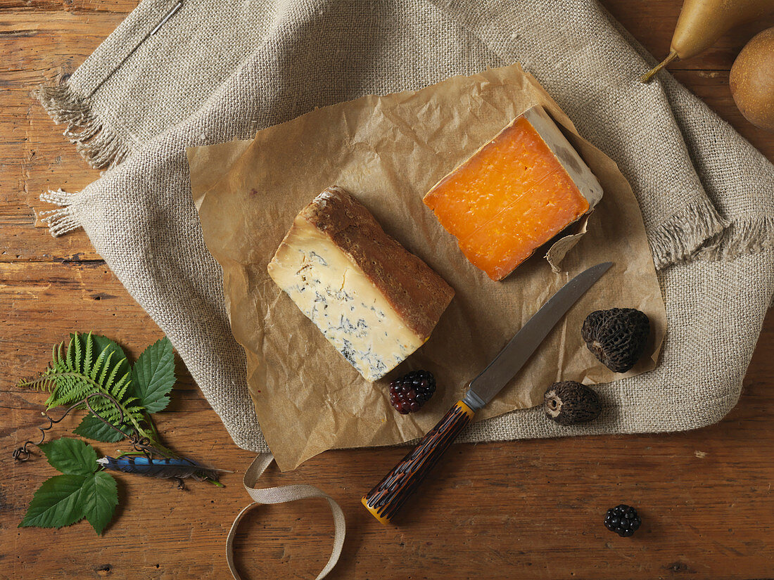 Two Wedges of Aged Cheese and Pearspears, bos On Wooden Surface with Knife