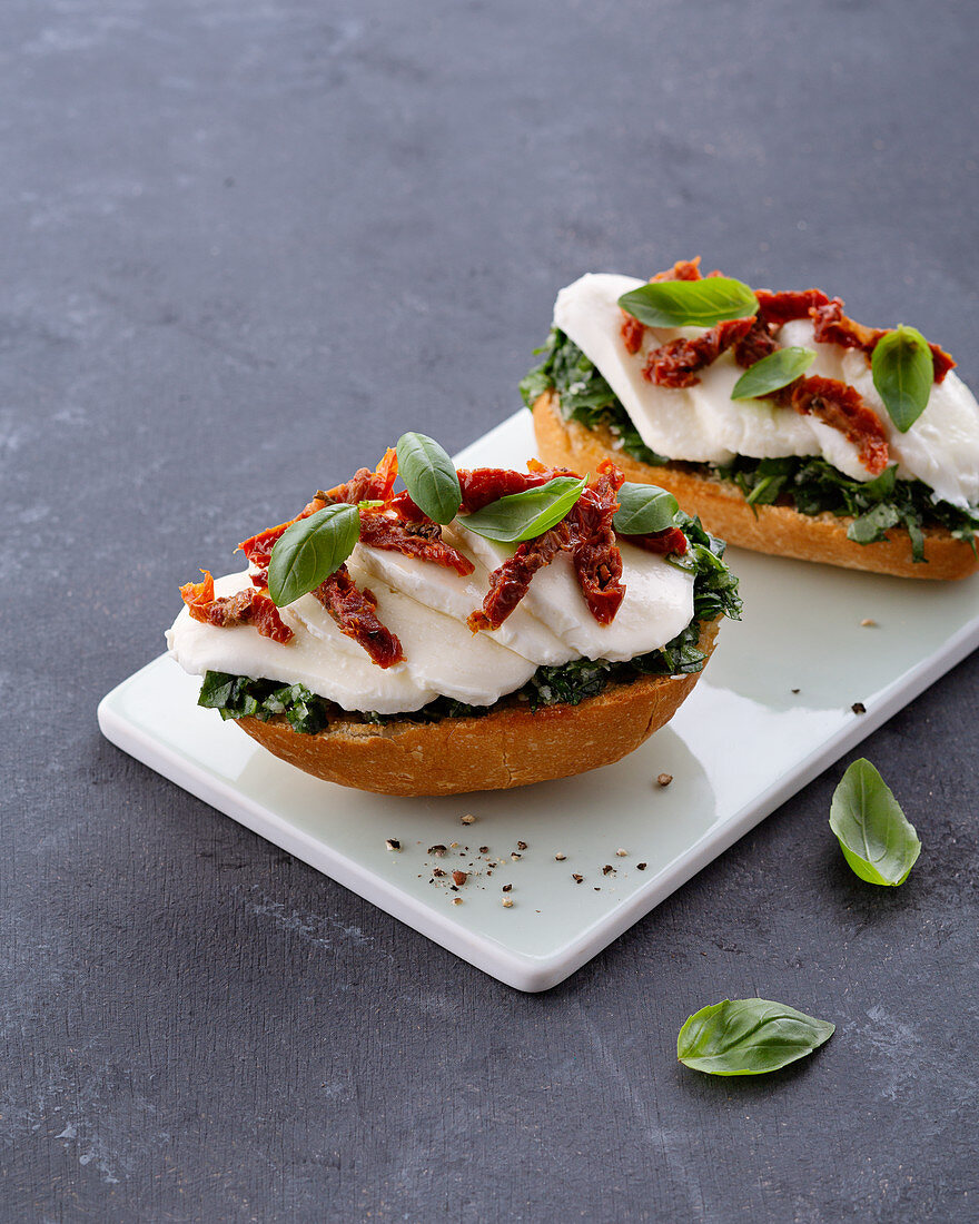 Mozzarella baguette with spinach, dried tomatoes and basil