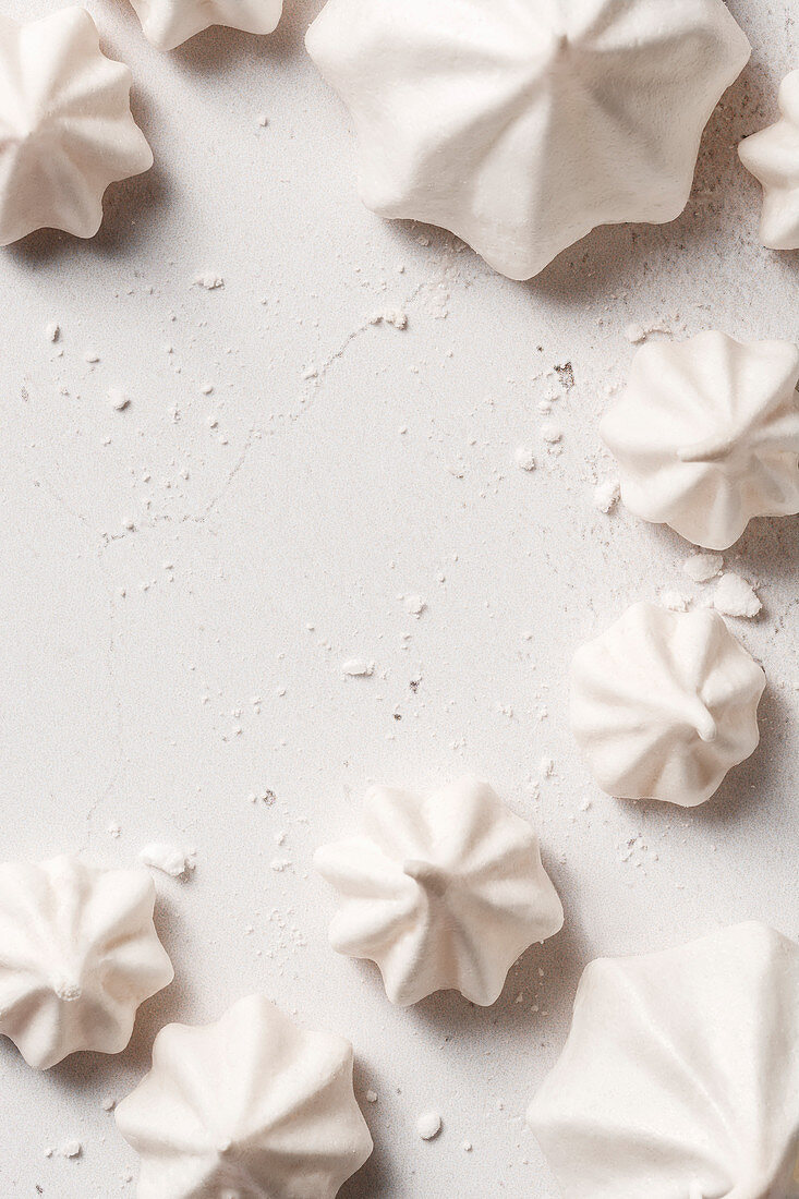 Meringues of different shapes on a white background