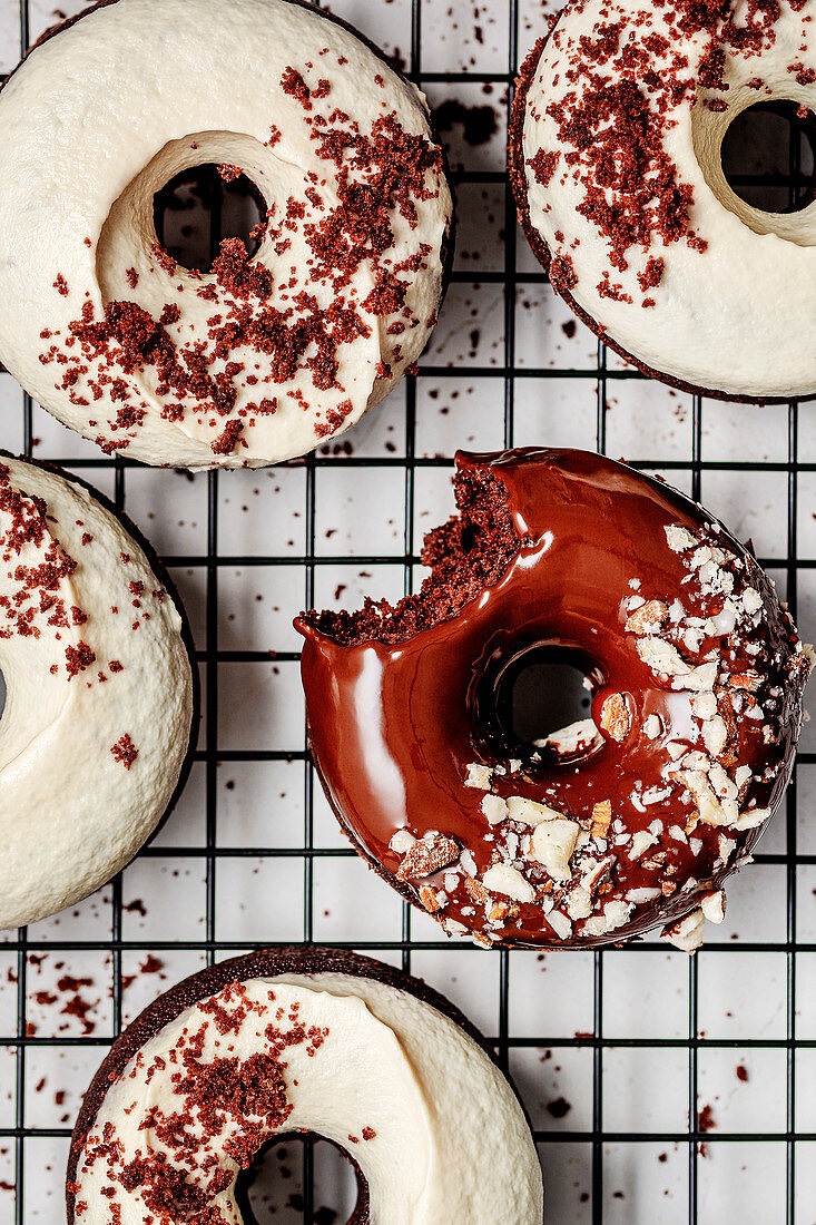 Baked chocolate donuts with chocolate glaze and cashew cream frosting