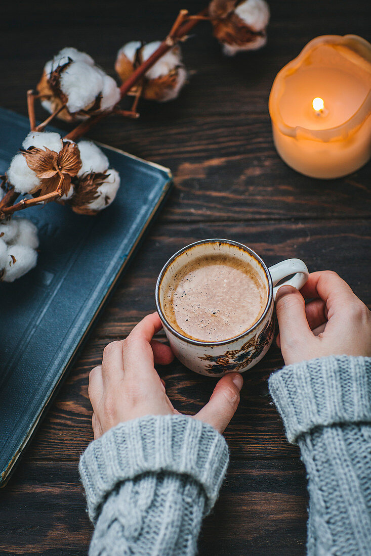 Woman holds cup of coffee