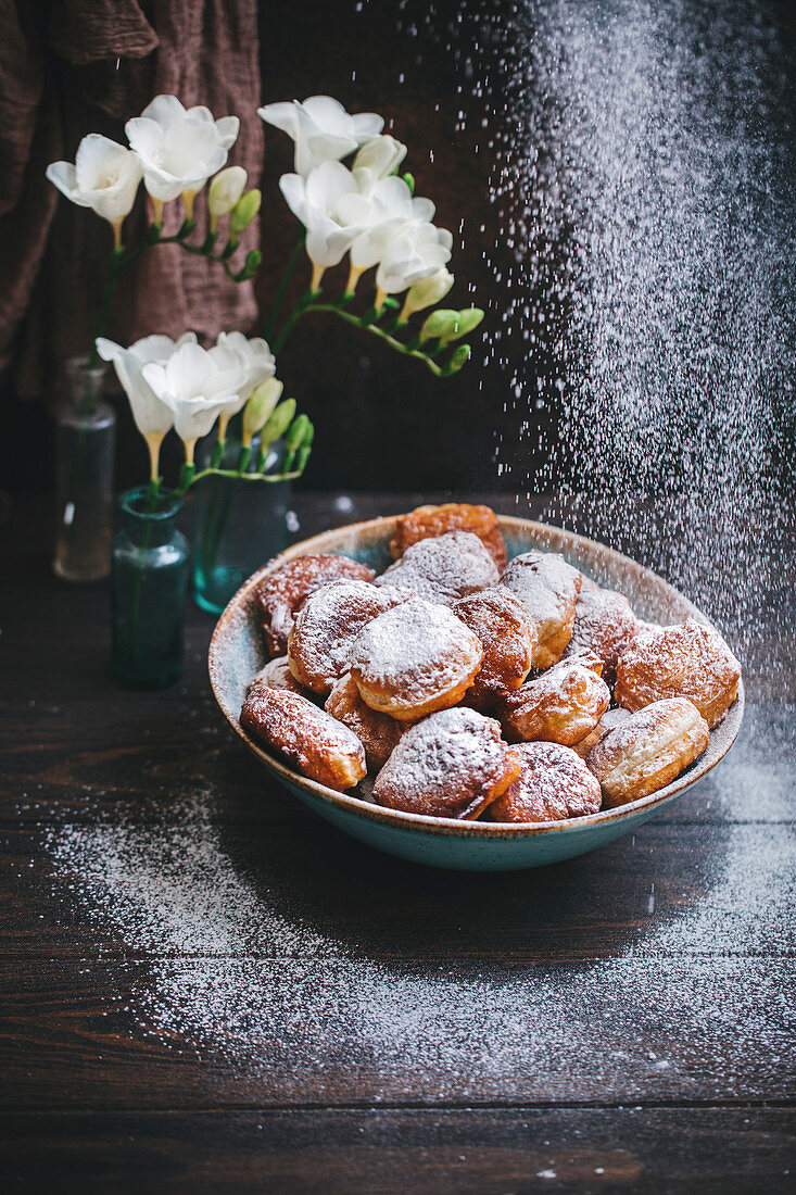 Sweet fritters dusted with powdered sugar