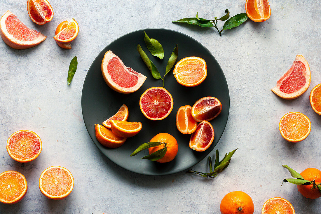 Fresh citrus fruit on a black plate