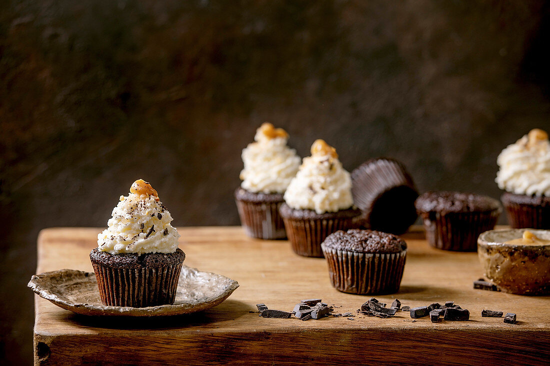 Chocolate muffins with white whipped butter cream and salted caramel
