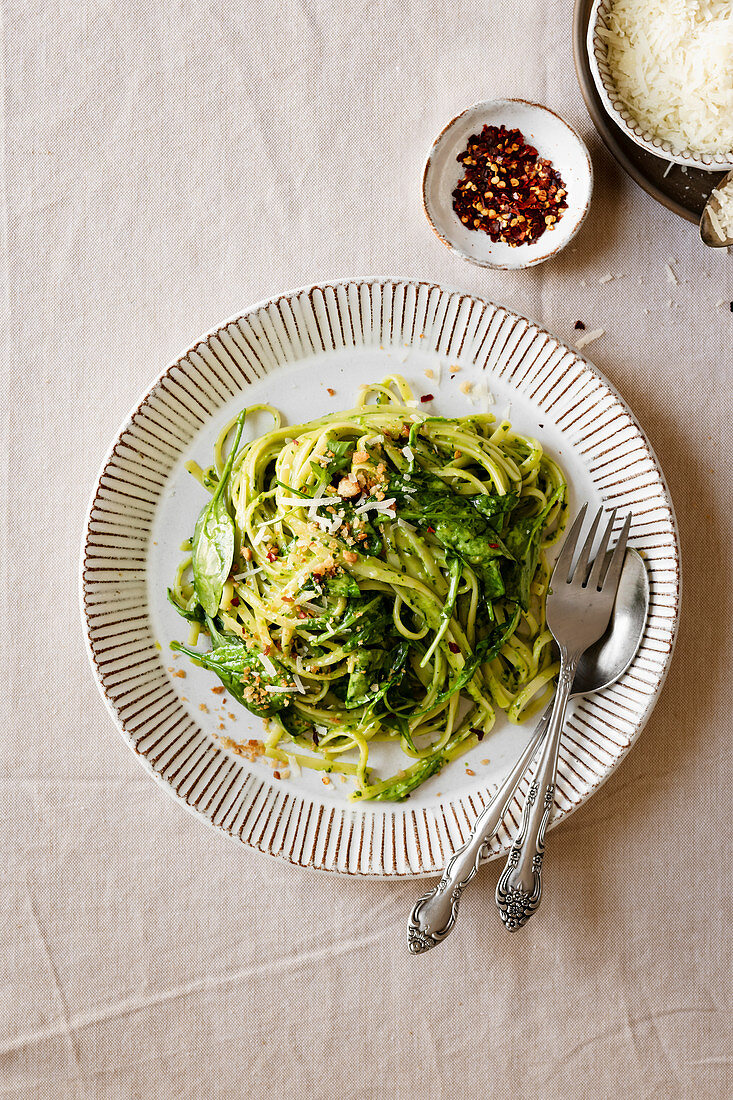 Creamy pesto pasta with crushed red pepper and Parmesan cheese