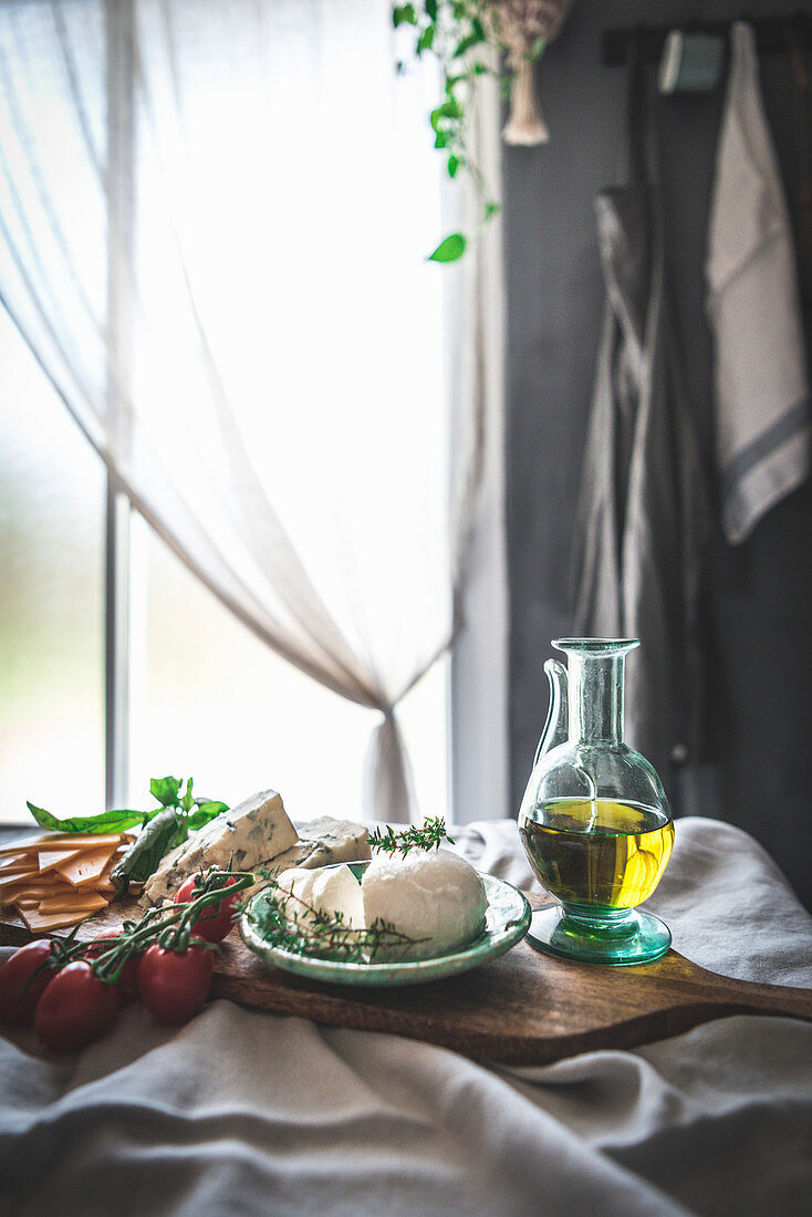 Mozzarella, tomatoes and olive oil on table