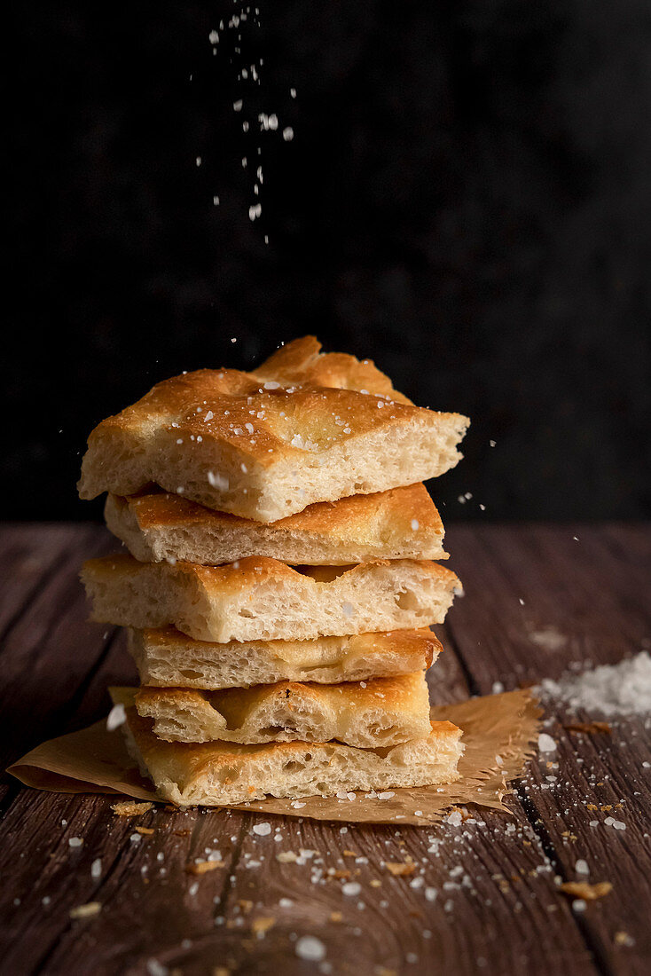Sliced focaccia bread with salt and olive oil