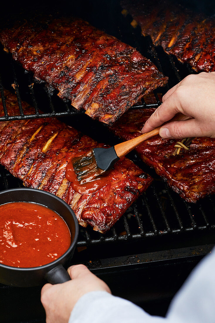 Brushing Saint Louis Style spare ribs with marinade