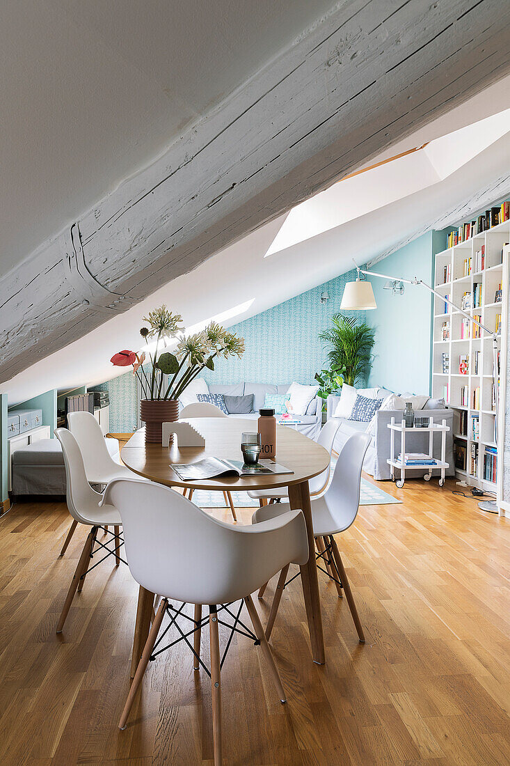 Shell chairs around a dining table in an attic apartment