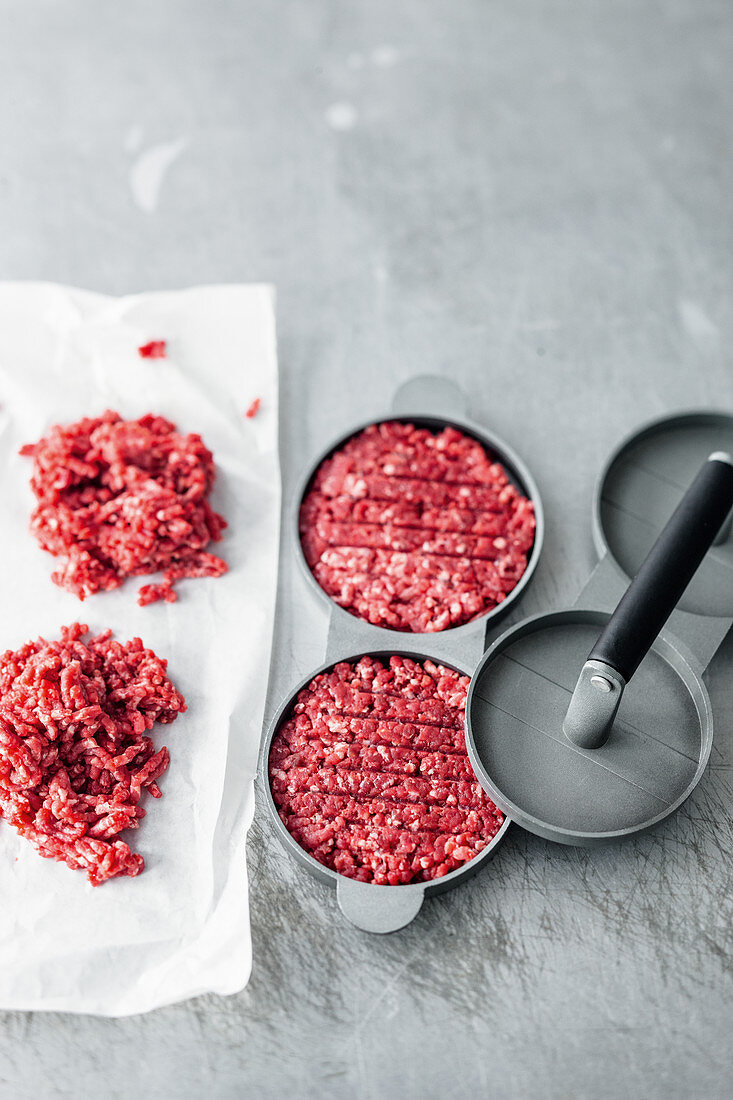 Ground beef in a burger press (for beef patties)