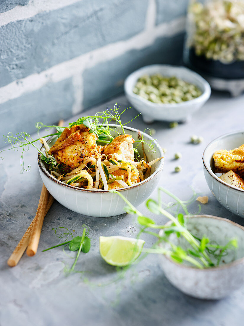 Crispy tofu with zucchini noodles and sprouts