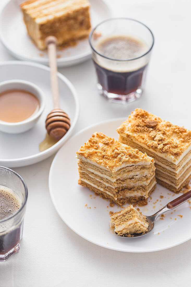 Slices of a honey cake served with coffee