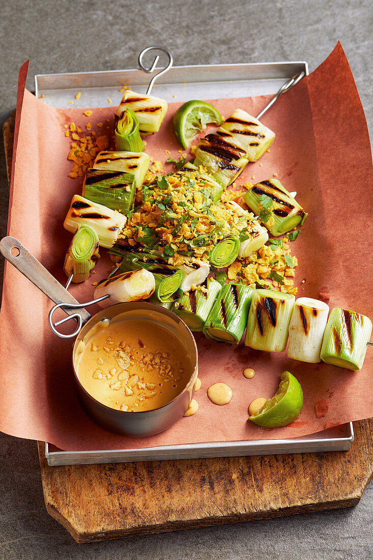 Grilled leek skewers with a spicy peanut sauce
