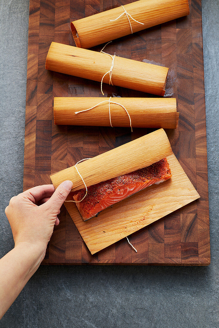 Salmon wrapped in woodsheets and tied with soaked kitchen thread
