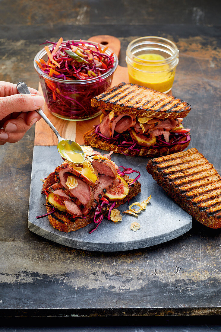 Grilled duck breast sandwich in 'pastrami style' with ruby red slaw