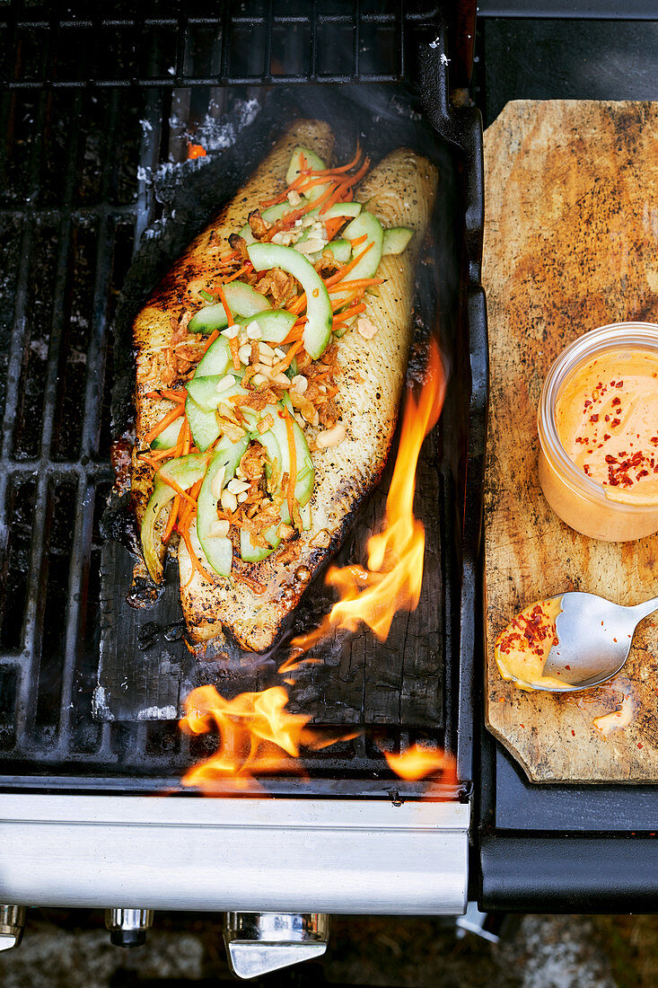 Halibut grilled on a cedar wood platter with Asian vegetables and peanuts