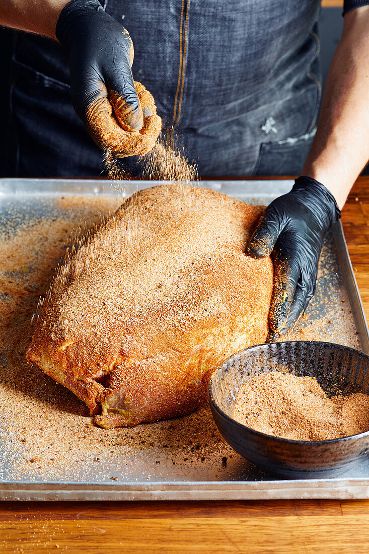 Prepare pulled pork: sprinkle a pork shoulder evenly with rub