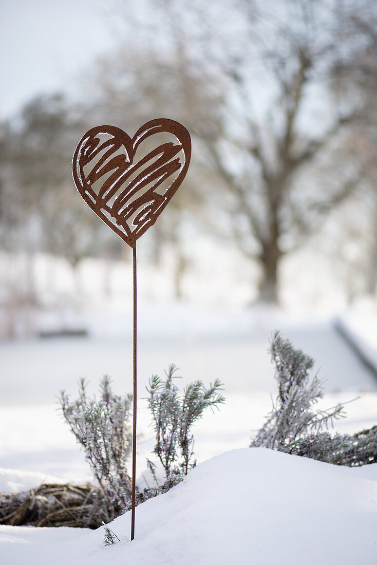 Rusty decorative heart in the snow