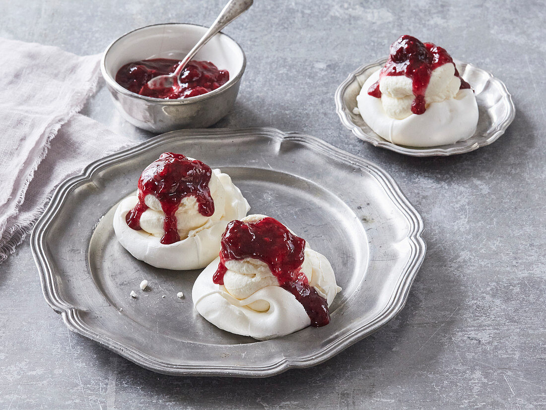 Small Pavlova meringues with whipped cream and forrest berries