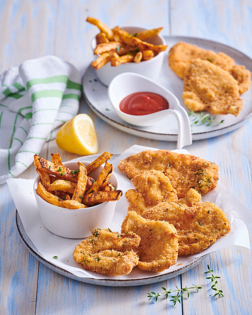 Small schnitzel in herb panko (breadcrumbs) with celery fries