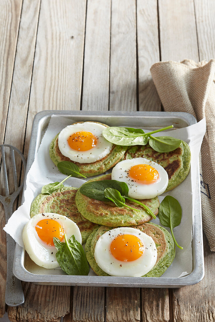 Spinach pancakes with fried eggs