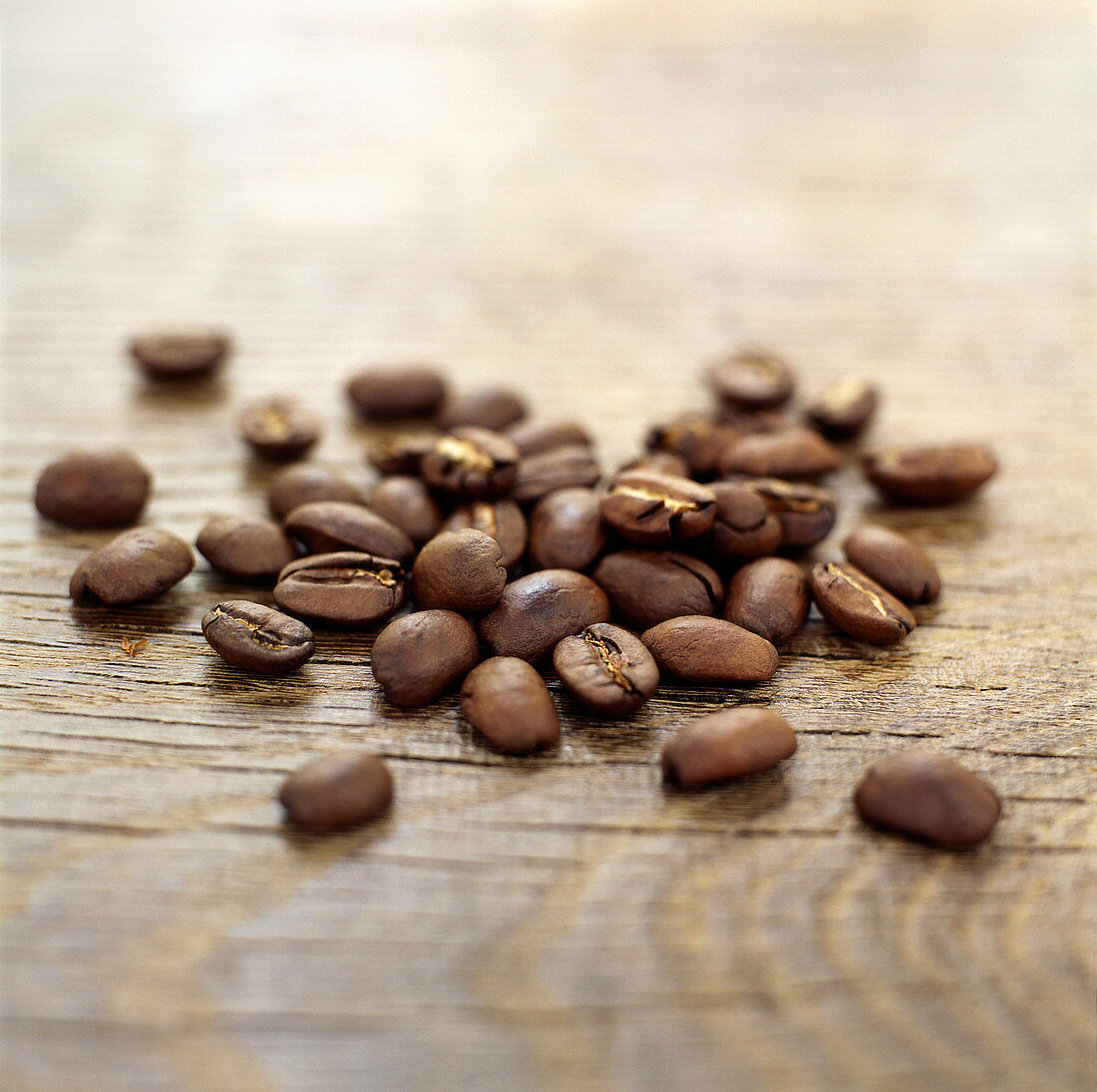 Coffee grains on wooden surface