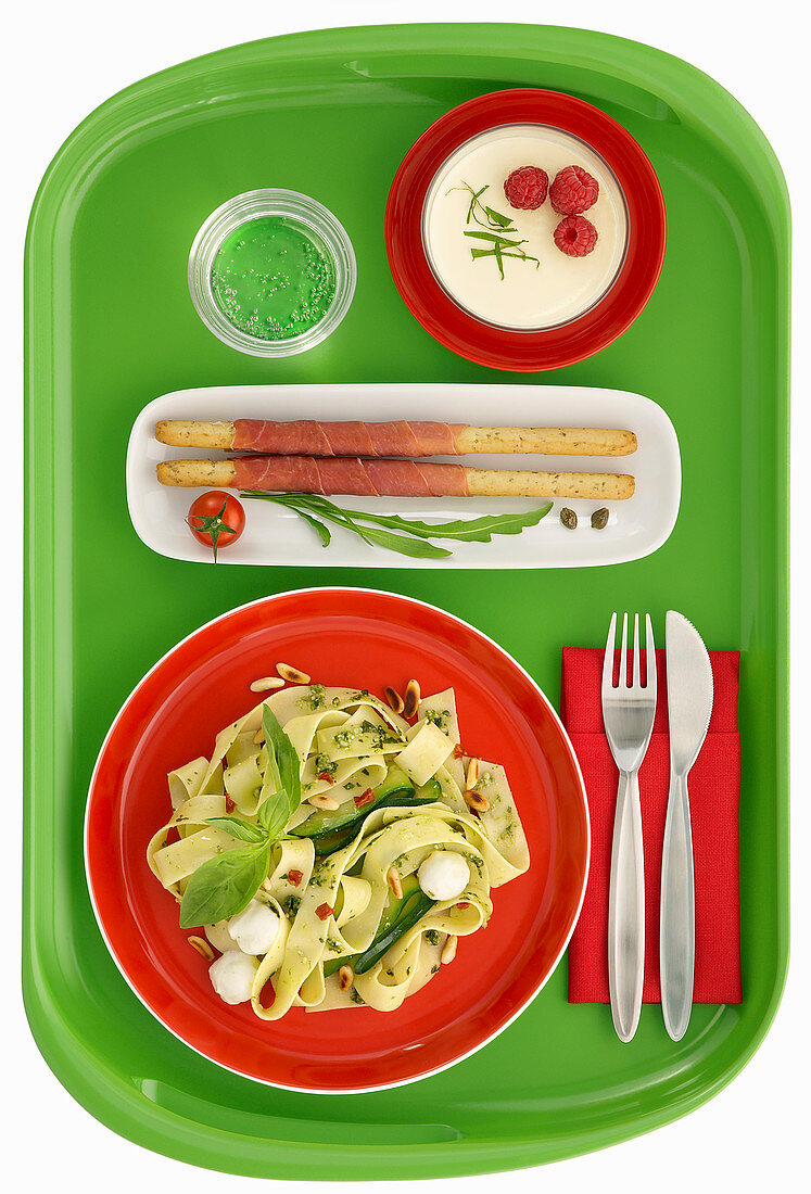 Green tray Italian theme with pasta , ham grissini and pannacota
