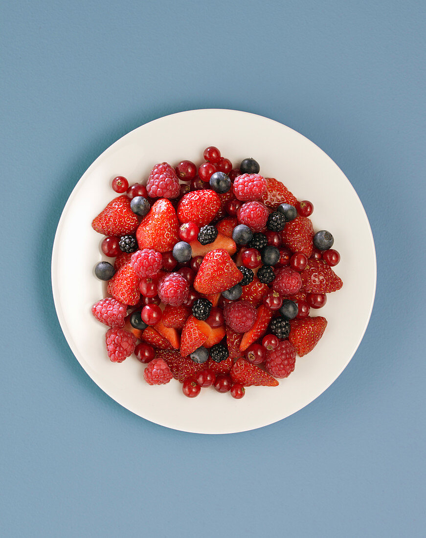 Red fruits in white plate