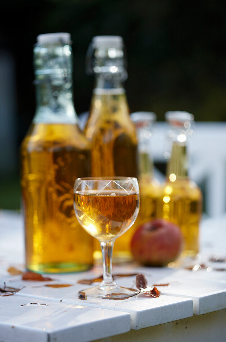 Apple juice in glass and swing-top bottles
