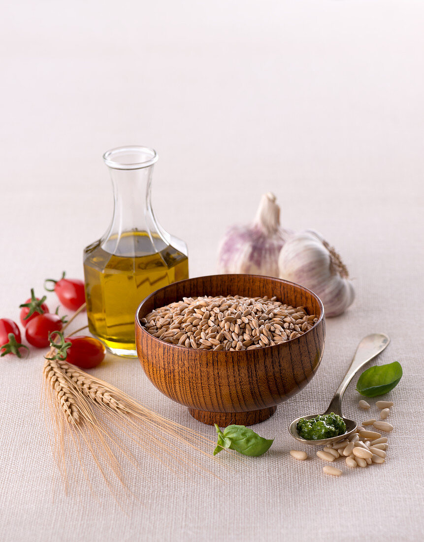 Uncooked barley in wooden bowl